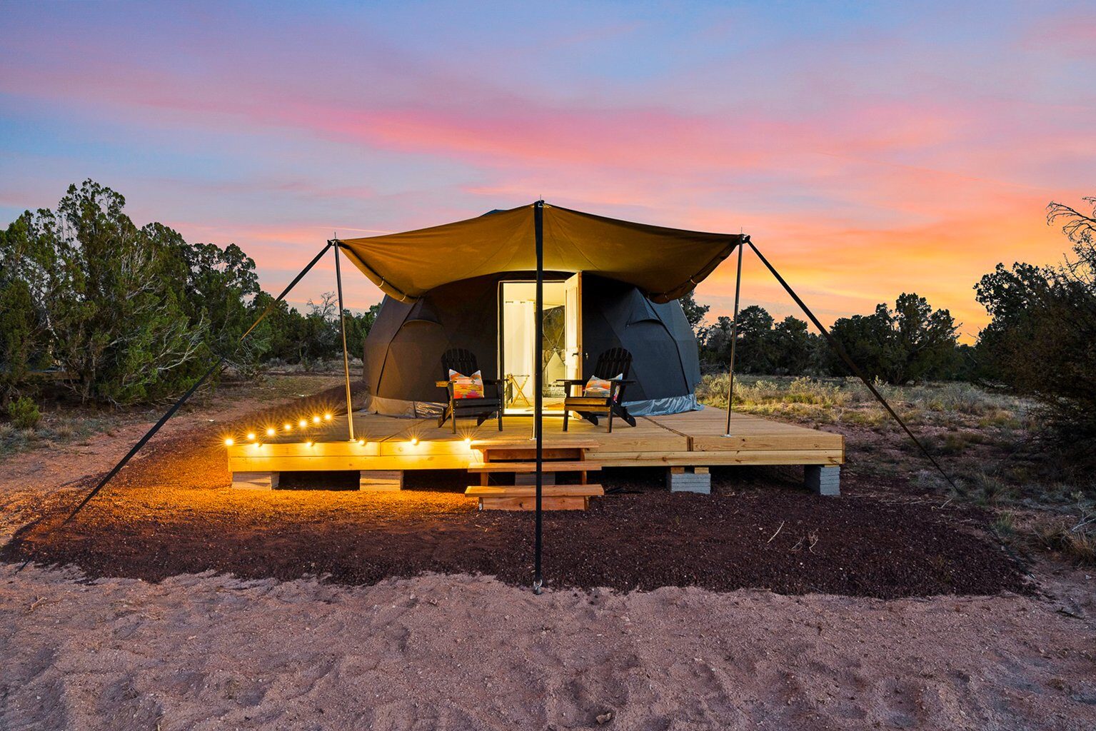 Safari tent on a raised platform at dusk